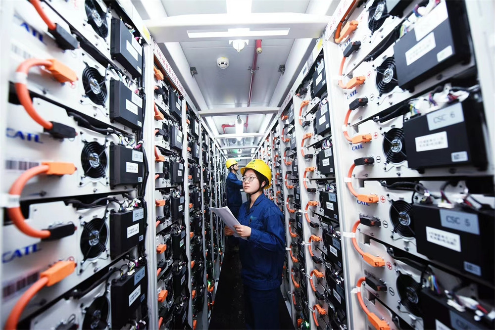 Technicians inspecting a large-scale energy storage system.